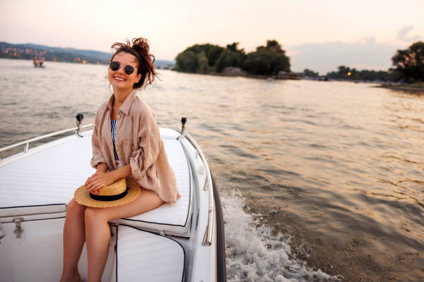 istock Woman enjoying summer vacation relaxing while sailing on a boat 2063705270