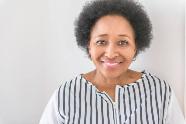 istock senior woman using her cellphone on white room 2063706407