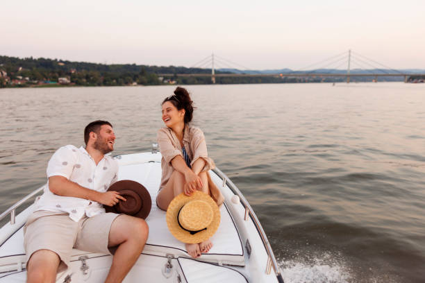 istock Couple relaxing and enjoying summer breeze while sailing on a boat 2063706958