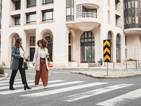 Mature business women crossing a pedestrian crossing in Lisbon