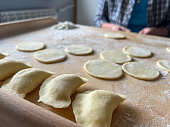 Home-made dumplings, kneading the dough by hand, rolling it, cutting it out and gluing it together