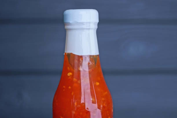 istock one glass bottle with red sauce with white cork 2063723971