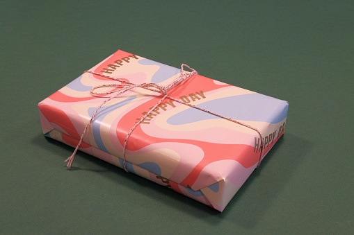 A gift wrapped in paper with a green background