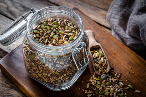 istock Roasted sunflower and pumpkin seeds mixture in a glass container 2063763536
