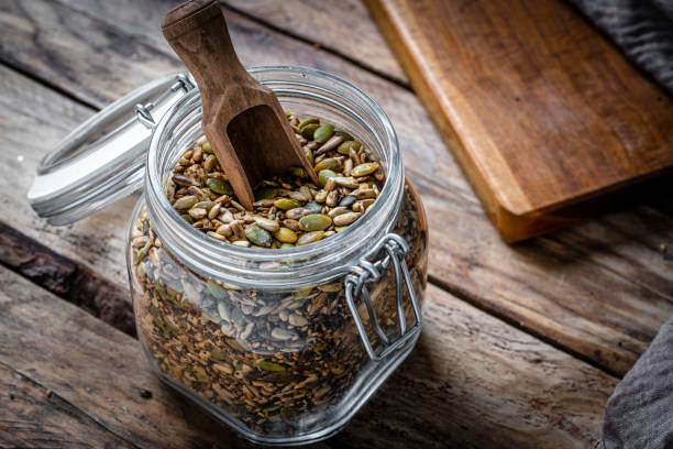 istock Roasted sunflower and pumpkin seeds mixture in a glass container 2063763550