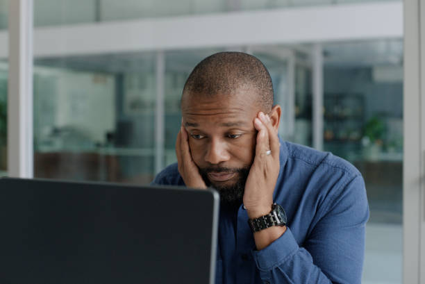 istock Laptop, depression and headache with business black man in office for problem solving or solution. Computer, burnout or stress and unhappy mature employee in workplace with 404 error or glitch 2063769931