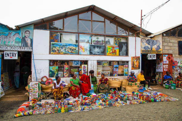 Arusha,Tanzania, Africa.02 february 2022. African masks, beaded bracelets, necklaces, Tanzanian national clothes, bags woven from natural material displayed and ready for sale. Calendars and tourism