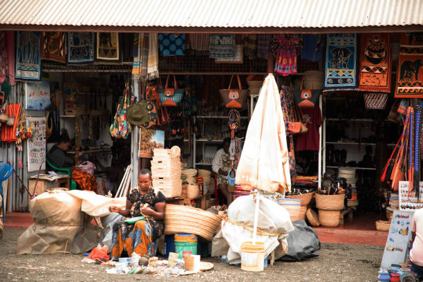 Arusha,Tanzania, Africa.02 february 2022. African masks, beaded bracelets, necklaces, Tanzanian national clothes, bags woven from natural material displayed and ready for sale. Calendars and tourism