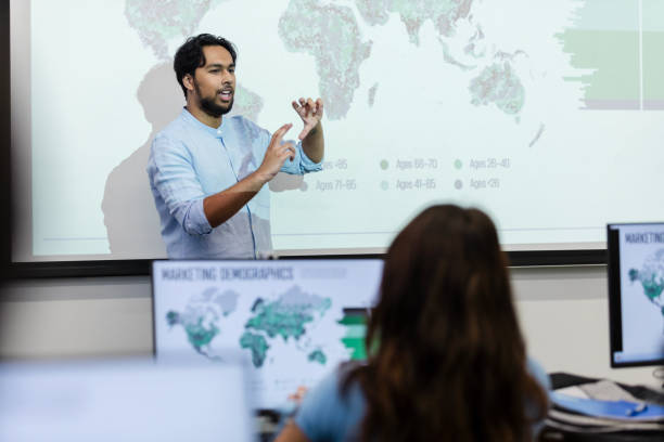 istock Young adult male professor gestures while speaking 2063789105