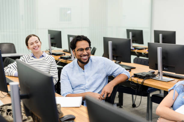 istock Diverse group of colleagues smile and enjoy conversation with each other 2063789660