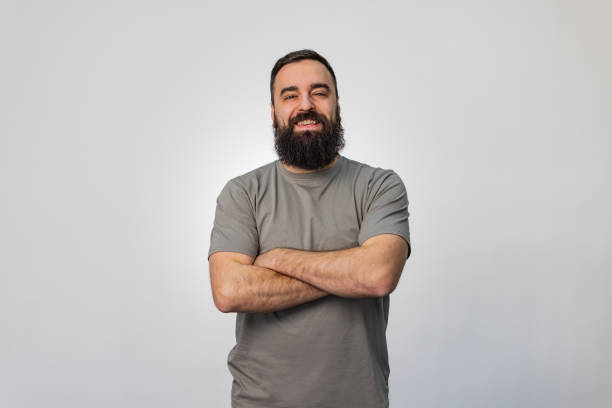istock Three quarter length of a cheerful businessman wearing casual shirt looking directly at camera while posing in studio 2063793473