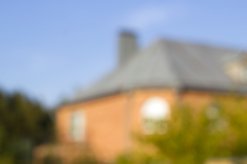 unfocused background with red house in the woods