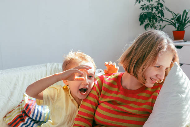 istock brother with his older sister in a bright room 2063805870