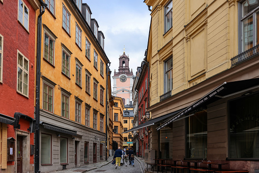 Stockholm, Sweden - July 25, 2023: Charming narrow cobbled street in Gamla Stan historic district of Stockholm, Sweden.