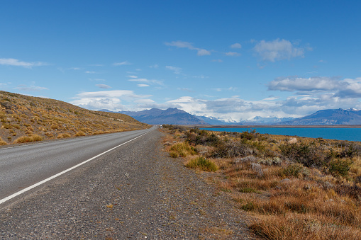 Empty road in El Calafate towards perito moreno, Patagonia with a blue sky and snow mountains, Argentina