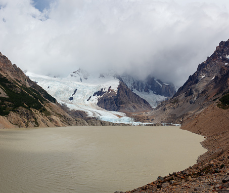 Laguna and glacier torre with the peaks covered in thick clouds in el chalten argentina.
