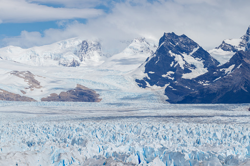 Perito Moreno seen close up with mountain landcape background in argentina.