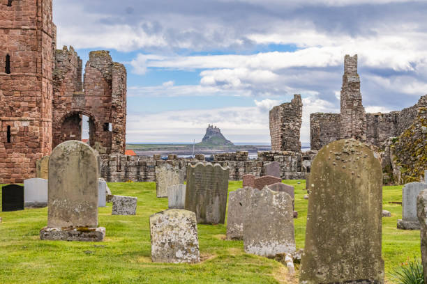 Graveyard at the ruins of the Lindisfarne Priory. Lindisfarne, Holy Island, Berwick-upon-Tweed, Northumberland, England, Great Briton, United Kingdom. May 1, 2022. Graveyard at the ruins of the Lindisfarne Priory. lindisfarne monastery stock pictures, royalty-free photos & images