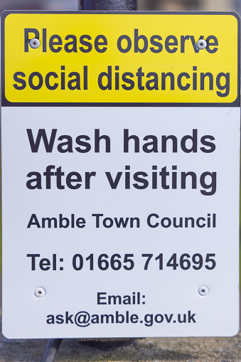 Amble, Morpeth, Northumberland, England, Great Briton, United Kingdom. May 1, 2022. Sign asking visitors to wash their hands and observe social distancing.