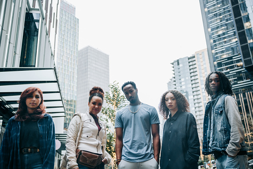 A group of African American friends look at the camera for a serious portrait.  Youth culture, style, fashion, and identity. Shot in Seattle, Washington, USA.  Horizontal with copy space.