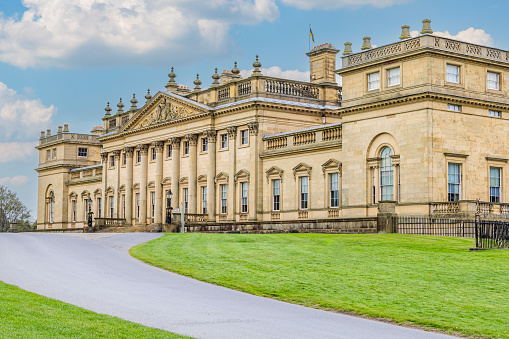 Harewood, Leeds, West Yorkshire, England, Great Briton, United Kingdom. May 2, 2022. Exterior view of Harewood House, an 18th Century Treasure House. Sky is digital composite.