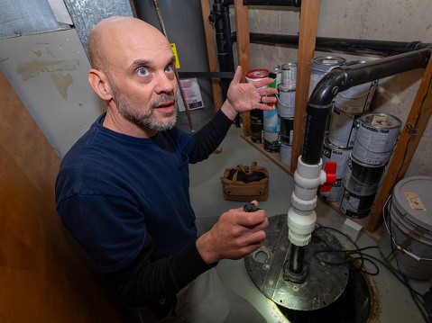 Plumber adjusts gas boiler before operating.