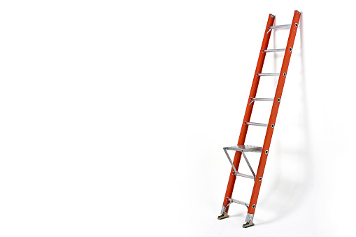 Step ladder on white wall with space for text, ladder isolated on white background