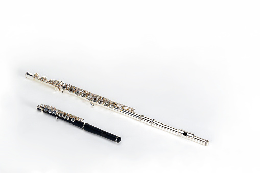 Silver and black metal flute isolated on white background with space for your text or design
