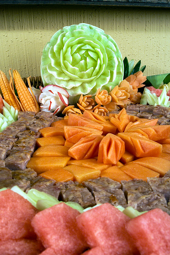 plate of chopped tropical fruits for buffet close up view, decoration with fruits
