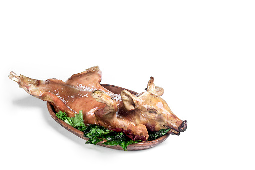 whole baked suckling pig isolated on white background with space for your text or design, gastronomy