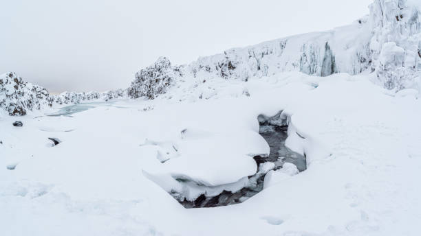 Oxarafoss, or the waterfall in the Ax River, in the Thingvellir national park in winter, Iceland