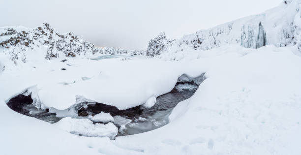 Oxarafoss, or the waterfall in the Ax River, in the Thingvellir national park in winter, Iceland