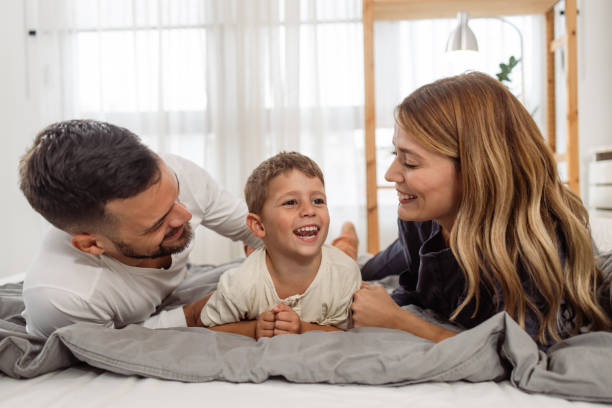 istock Young family cuddling in bed 2063969036