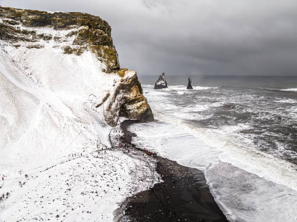 istock Extremely windy day at Reynisfjara black beach with big waves and rock formations in the Atlantic Ocean 2064001898