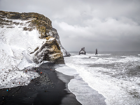 Rynisfjara Black Sand Lava Beach view. Drone Point of view to the famous Reynisdrangar Basalt Sea Stack Cliffs in the North Atlantic Ocean along Rynisfjara Black Sand Lava Beach, close to Vik i Myrdal, South Central Iceland, Iceland, Nordic Countries, Europe