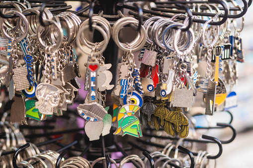 Traditional tourist souvenirs and gifts from Greece, fridge magnets with text Greece, and key ring keychain, mugs and toys in a local vendor shop in Athens, Attica, Greece, greek souvenirs