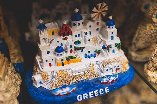 Traditional tourist souvenirs and gifts from Greece, fridge magnets with text Greece, and key ring keychain, mugs and toys in a local vendor shop in Athens, Attica, Greece, greek souvenirs