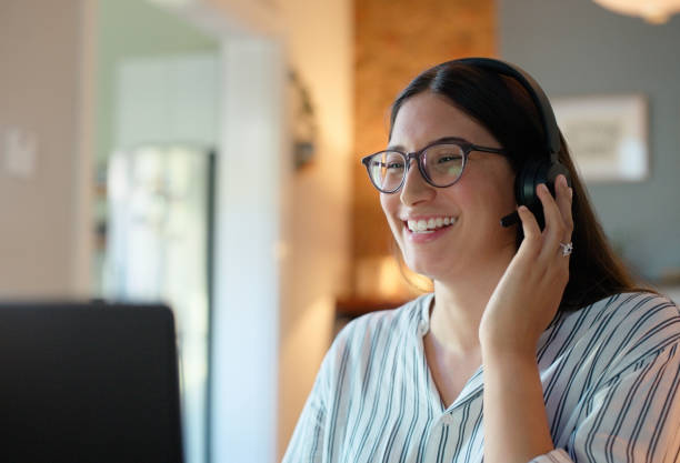 istock Woman, headset and consultant on laptop in home, call centre representative and remote work. Happy female person, speaking and communication for technical support, operator and online for contact 2064007130