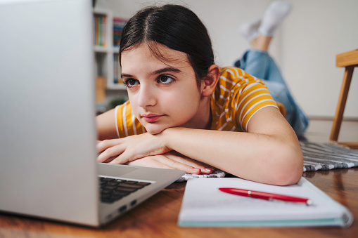 Studying from home. Girl is Working on Homework for School. Education Concept