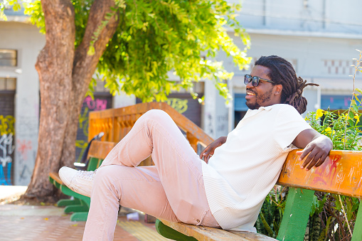 man sitting and talking in his city square