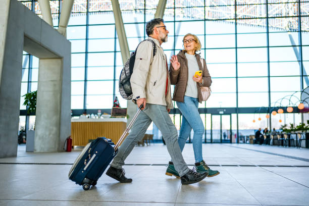 Mature couple of passengers at the train station stock photo