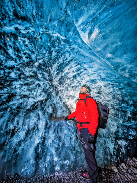 istock Tourist discovering the ice cave in Falljokull Glacier (Falling Glacier) in Iceland 2064048219