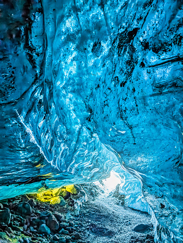 Entrance of an crystal blue ice cave with underground path inside Vatnajokull glacier, Iceland