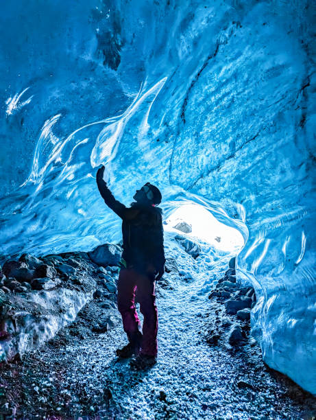 istock Hiking woman stand at ice cave 2064048639