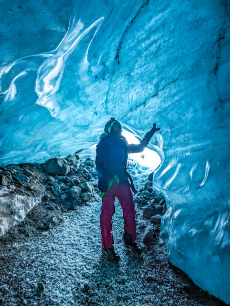 istock Hiking woman stand at ice cave 2064048642
