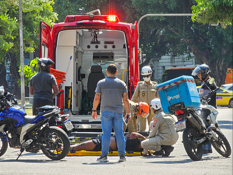 March 3rd, 2024 - Rio de Janeiro, Brazil: A man lying on the ground is treated by fire paramedics before taking him to the ambulance. The accident occurred in the Flamengo neighborhood, south of Rio de Janeiro.