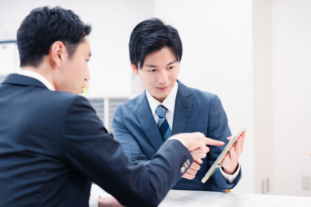 istock Businessman using a tablet terminal to explain at the counter. 2064133983
