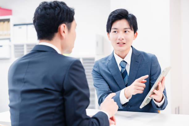 istock Businessman using a tablet terminal to explain at the counter. 2064133988