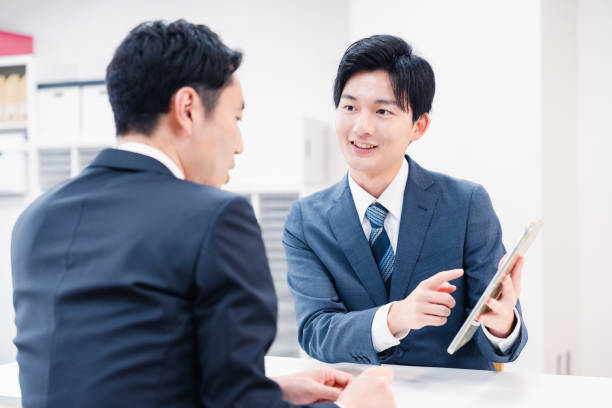 istock Businessman using a tablet terminal to explain at the counter. 2064133991