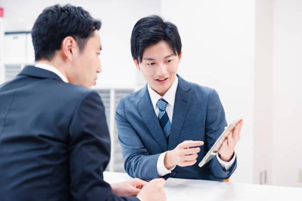 istock Businessman using a tablet terminal to explain at the counter. 2064133996